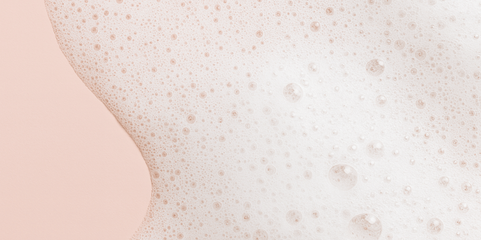 Bilden visar en rosa bakgrund vita bubblor och skum.