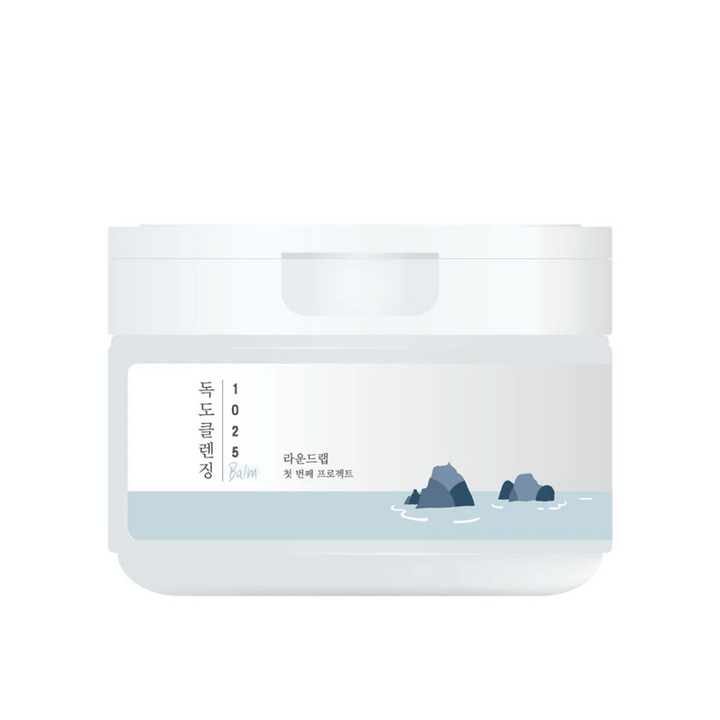 Zaprt bel lonček 1025 Dokdo Cleansing Balm z minimalistično morsko temo na etiketi, na beli podlagi.