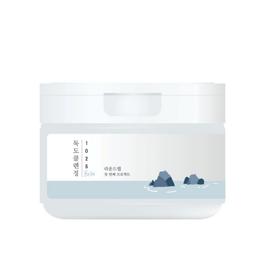 Zaprt bel lonček 1025 Dokdo Cleansing Balm z minimalistično morsko temo na etiketi, na beli podlagi.