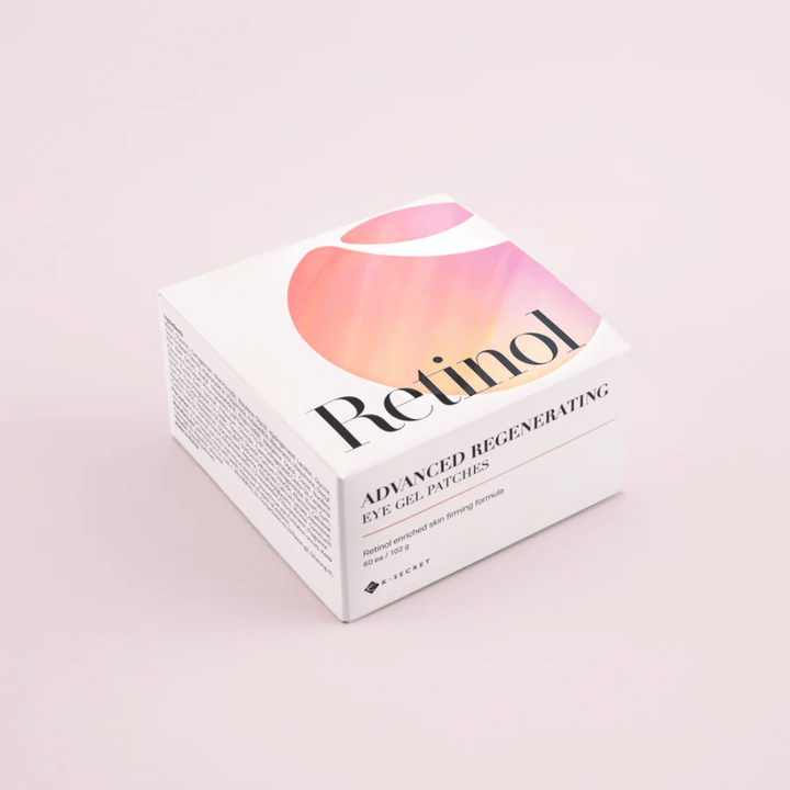 Embalaža K-Secret Advanced Regenerating Eye Gel Patches z retinolom v beli in rožnati zasnovi.