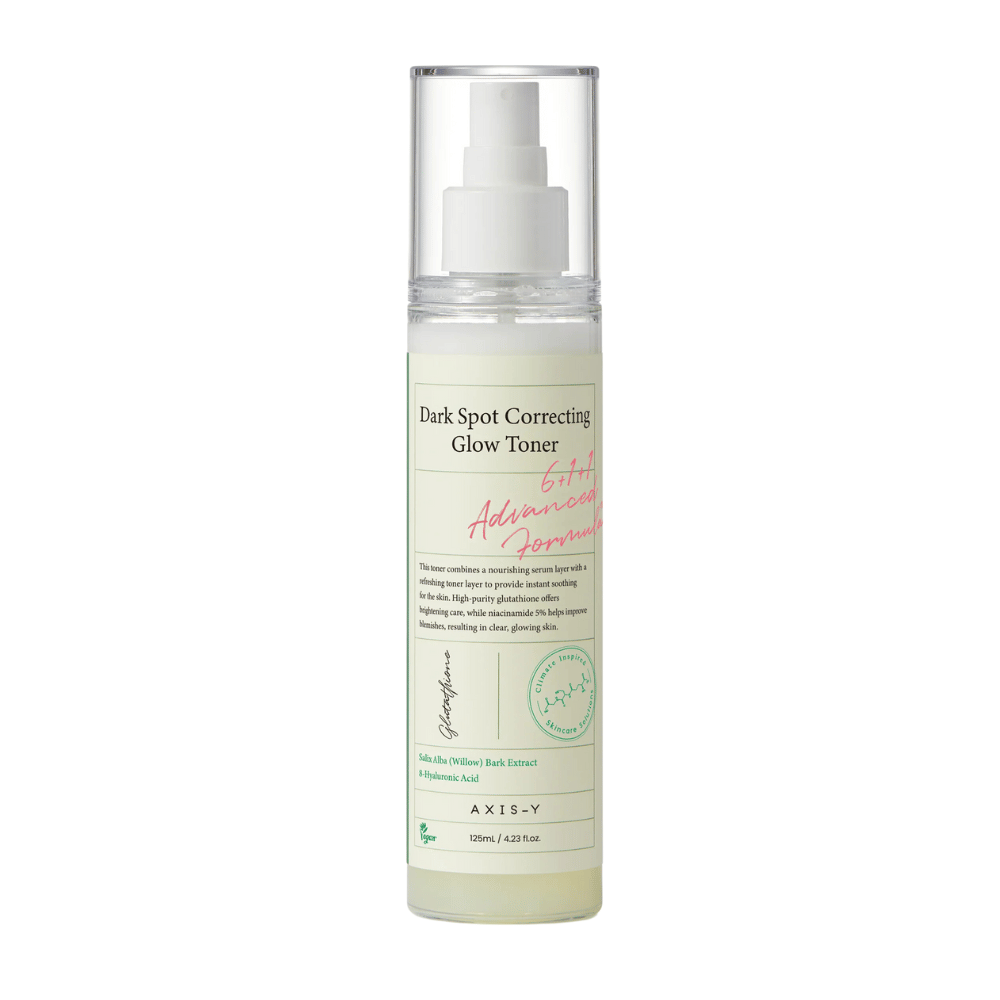 Slika steklenice izdelka "AXIS-Y Dark Spot Correcting Glow Toner". Steklenica je prozorna z belo etiketo in črnim ter zelenim besedilom. Izdelek je toner v obliki razpršila, steklenica pa vsebuje 125 ml (4,23 fl. oz). Etiketa navaja ključne sestavine, kot sta izvleček vrbovega lubja in hialuronska kislina.