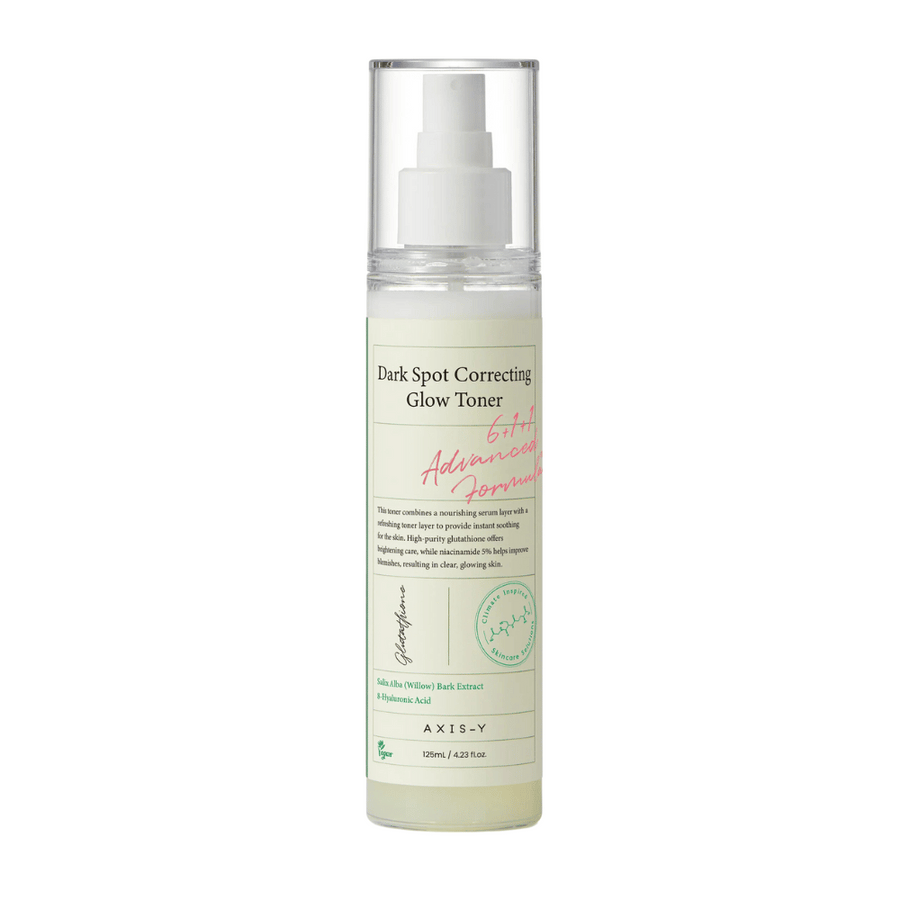 Slika steklenice izdelka "AXIS-Y Dark Spot Correcting Glow Toner". Steklenica je prozorna z belo etiketo in črnim ter zelenim besedilom. Izdelek je toner v obliki razpršila, steklenica pa vsebuje 125 ml (4,23 fl. oz). Etiketa navaja ključne sestavine, kot sta izvleček vrbovega lubja in hialuronska kislina.