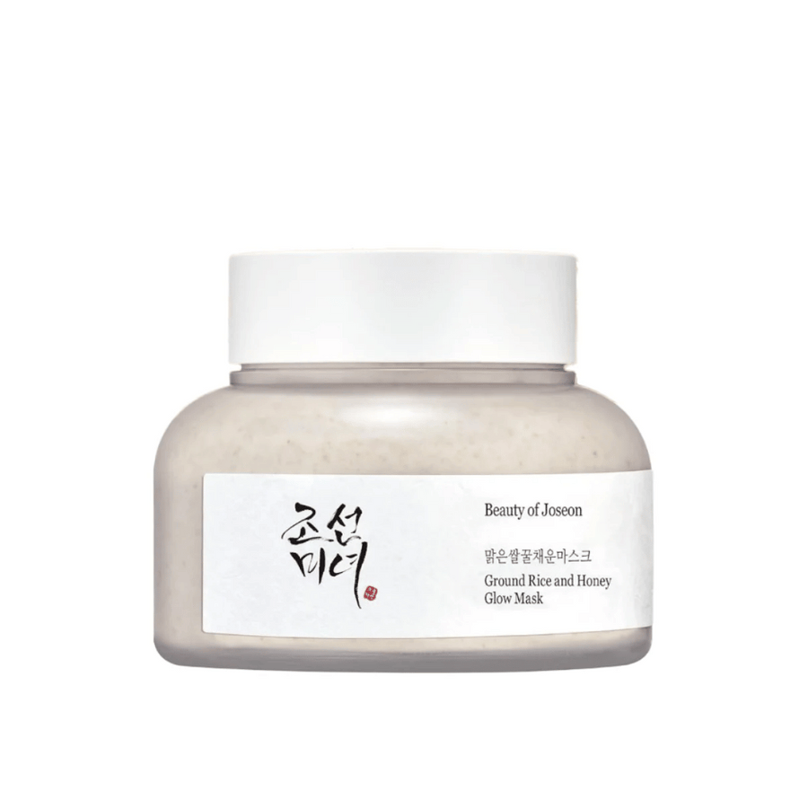 Kozarec "Beauty of Joseon Ground Rice and Honey Glow Mask". Embalaža je preprosta z belim pokrovom in etiketo, ki predstavlja ime izdelka in sestavine v korejščini in angleščini. Izdelek je zasnovan za sijaj in nego kože.