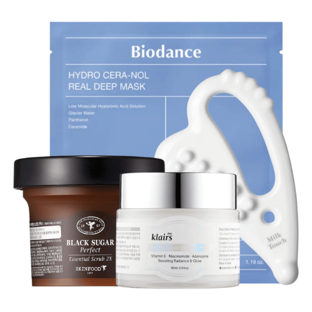 Slika prikazuje izbor izdelkov za nego kože, vključno z obrazno masko znamke Biodance, kozarec Black Sugar Perfect Essential Scrub 2X znamke Skinfood, kremo znamke Dear, Klairs, in belo orodje za masažo obraza znamke Milk Touch.
