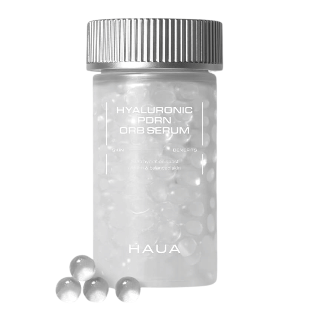 Slika izdelka HAUA Hyaluronic PDRN Orb Serum na belem ozadju. Prozorna embalaža je napolnjena s serumskimi kroglicami in poudarja edinstveno enkapsulirano formulacijo izdelka.