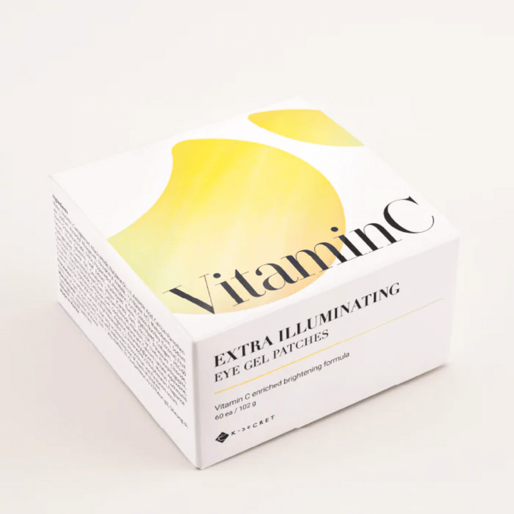 Embalaža K-Secret Extra Illuminating Eye Gel Patches z vitaminom C v beli in rumeni zasnovi.