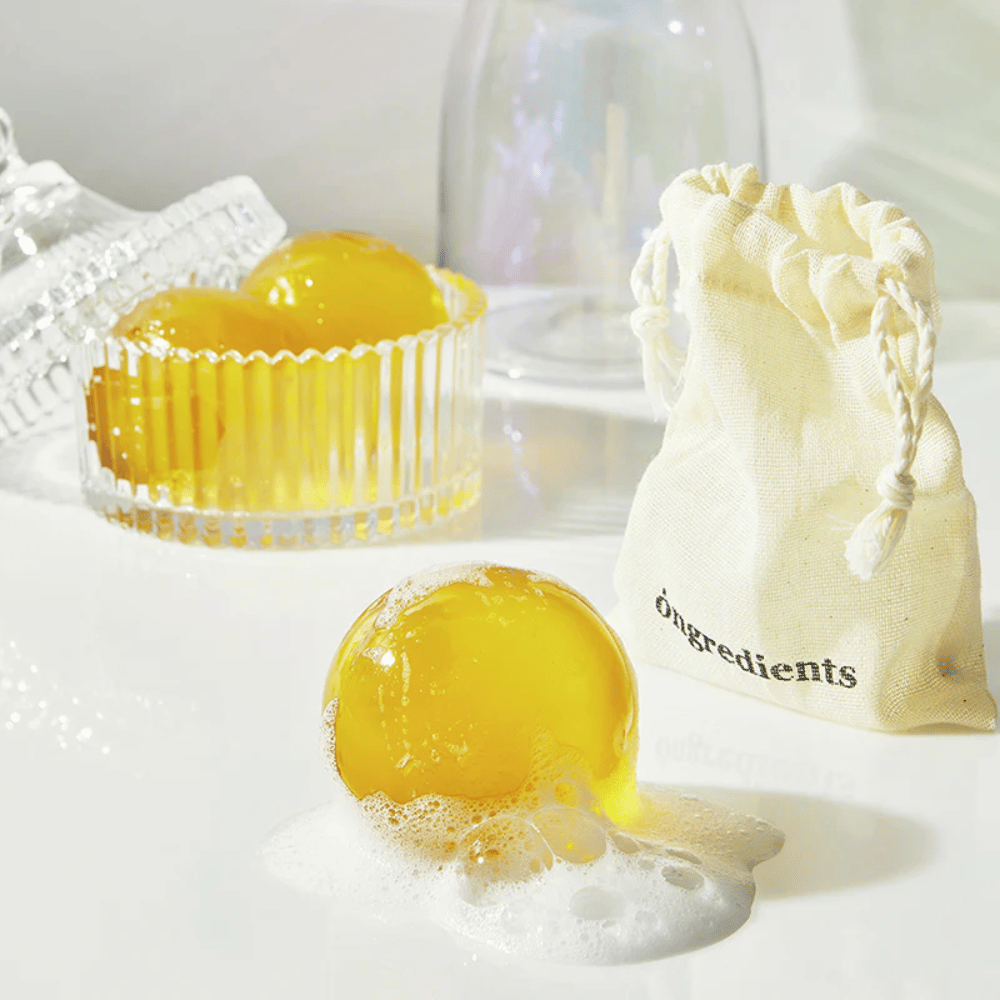 Jeju Cica Cleansing Ball iz Ongredients – penasta čistilna kroglica v steklenem kozarcu, priložena s tekstilno vrečko za vsakodnevno čiščenje obraza.