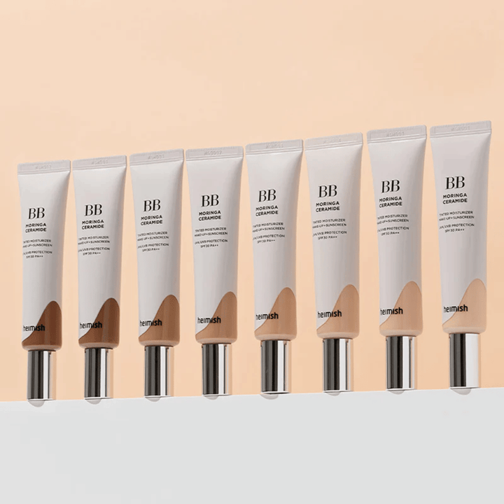 Vrsta Heimish Moringa Ceramide BB Cream v več barvnih odtenkih. Slika prikazuje razpon od svetlejših do temnejših tonik za obraz, da ustreza različnim tonom kože in potrebam.