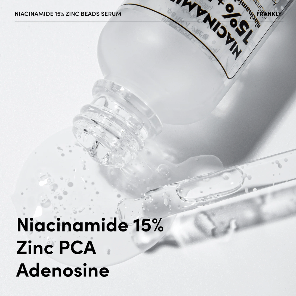 Povečana slika FRANKLY Niacinamide 15% + Zinc Beads Serum, ki se izliva. Besedilo prikazuje sestavine: Niacinamid 15 %, Zinc PCA in Adenosin.