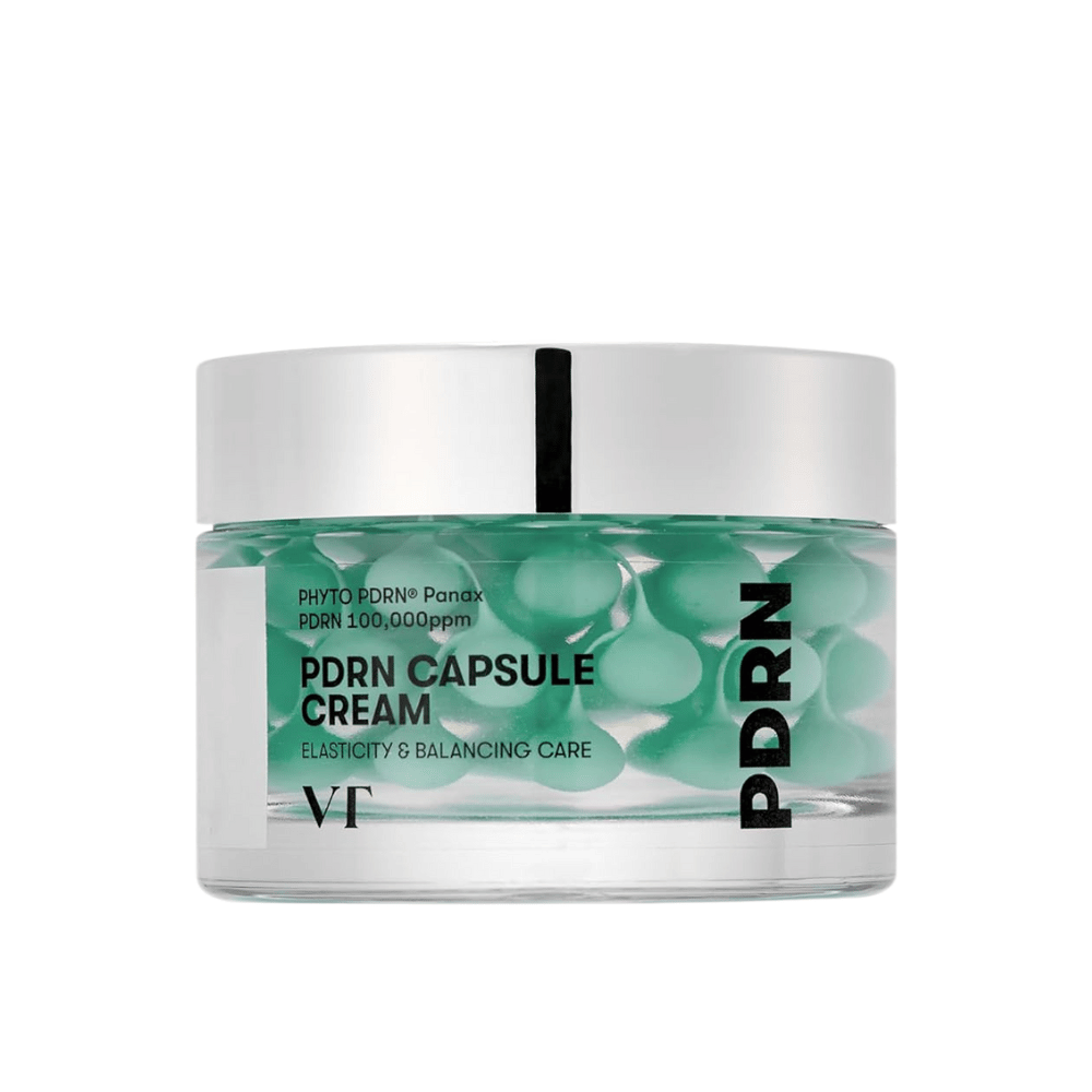 VT PDRN Capsule Cream v prozorni posodi s srebrnim pokrovom. Vsebina je sestavljena iz zelenih kapsul v prozorni gelu, oznaka pa prikazuje, da je krema namenjena elastičnosti in uravnoteženi negi kože.