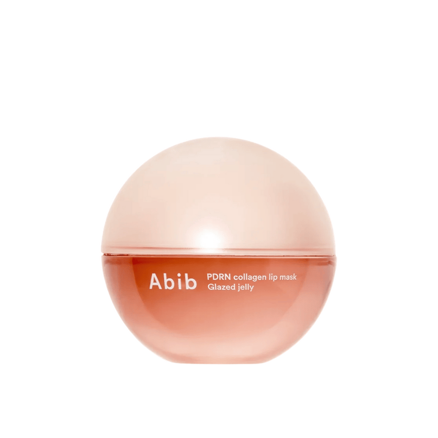 Roza okrogla posoda z napisom "Abib PDRN Collagen Lip Mask Glazed Jelly" na sprednji strani, fotografirana na beli podlagi.
