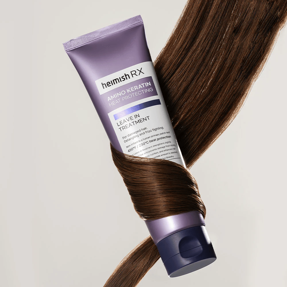 Heimish RX Amino Keratin Leave-In Treatment – hranilna toplotno zaščitna nega las, obdana s sijočimi lasmi, simbolizira krepitev in vlažilni učinek za poškodovane lase.
