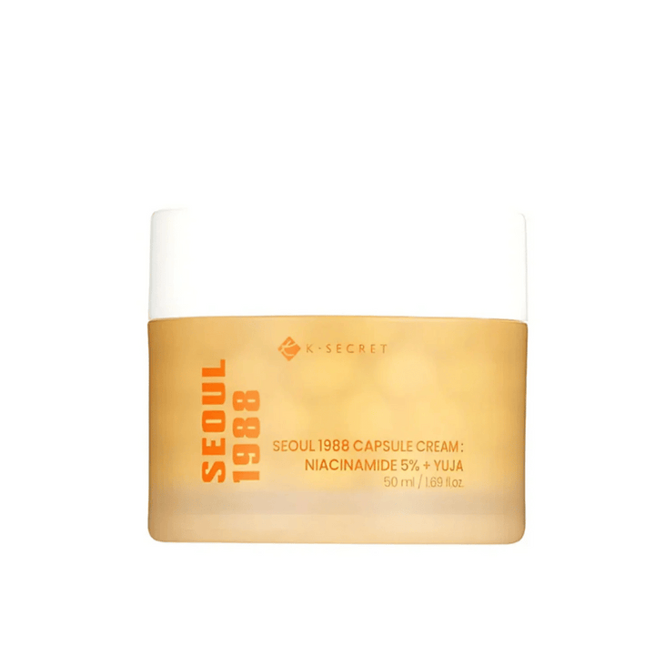 Posoda s K-Secret Seoul 1988 Capsule Cream Niacinamide 5% + Yuja, 50 ml, v zlato obarvani embalaži.