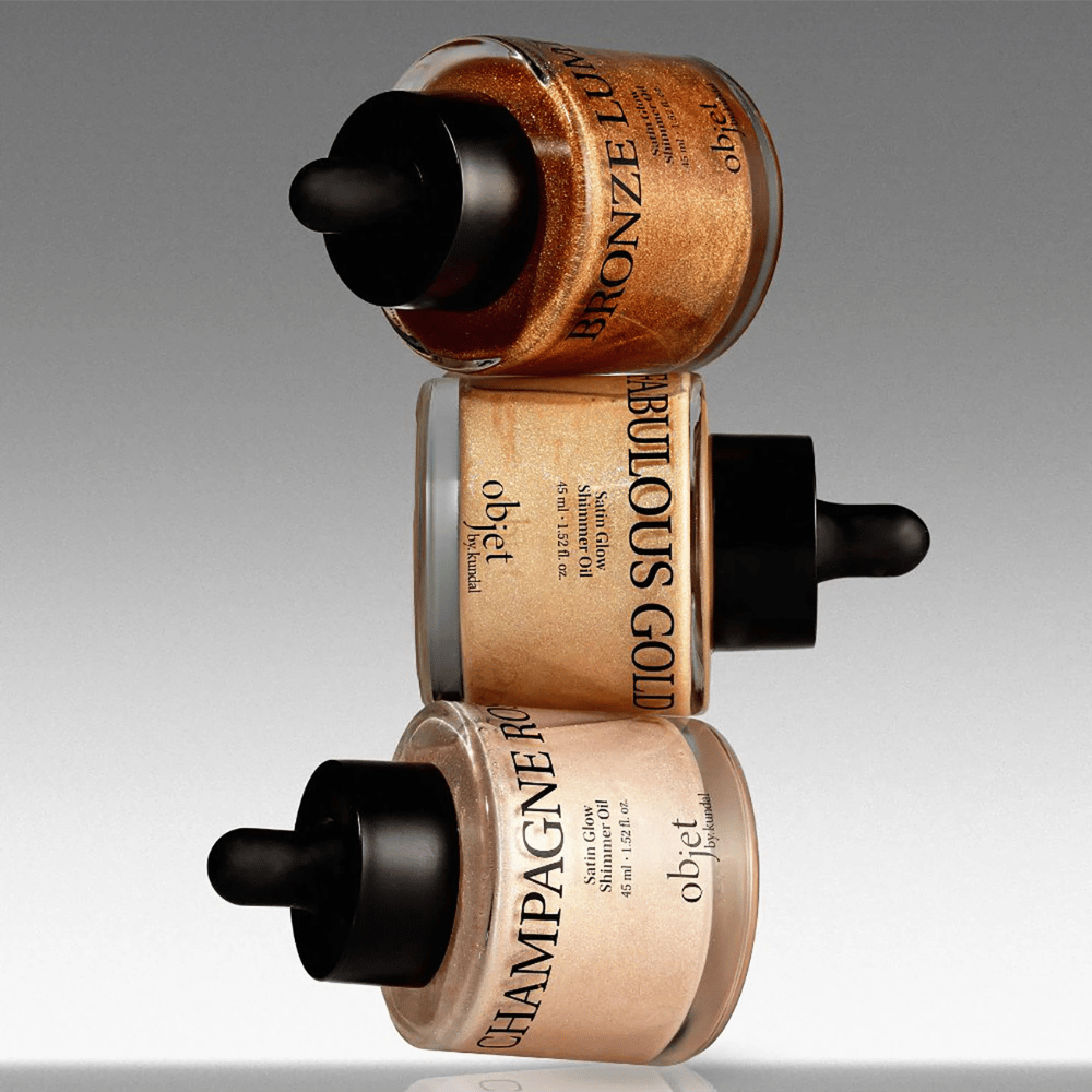 Objet by KUNDAL Satin Glow Shimmer Oil v odtenku Bronze Lumière, Fabulous Gold in Champagne Rose – bleščeča olja za telo z zaključkom, ki daje lesk.