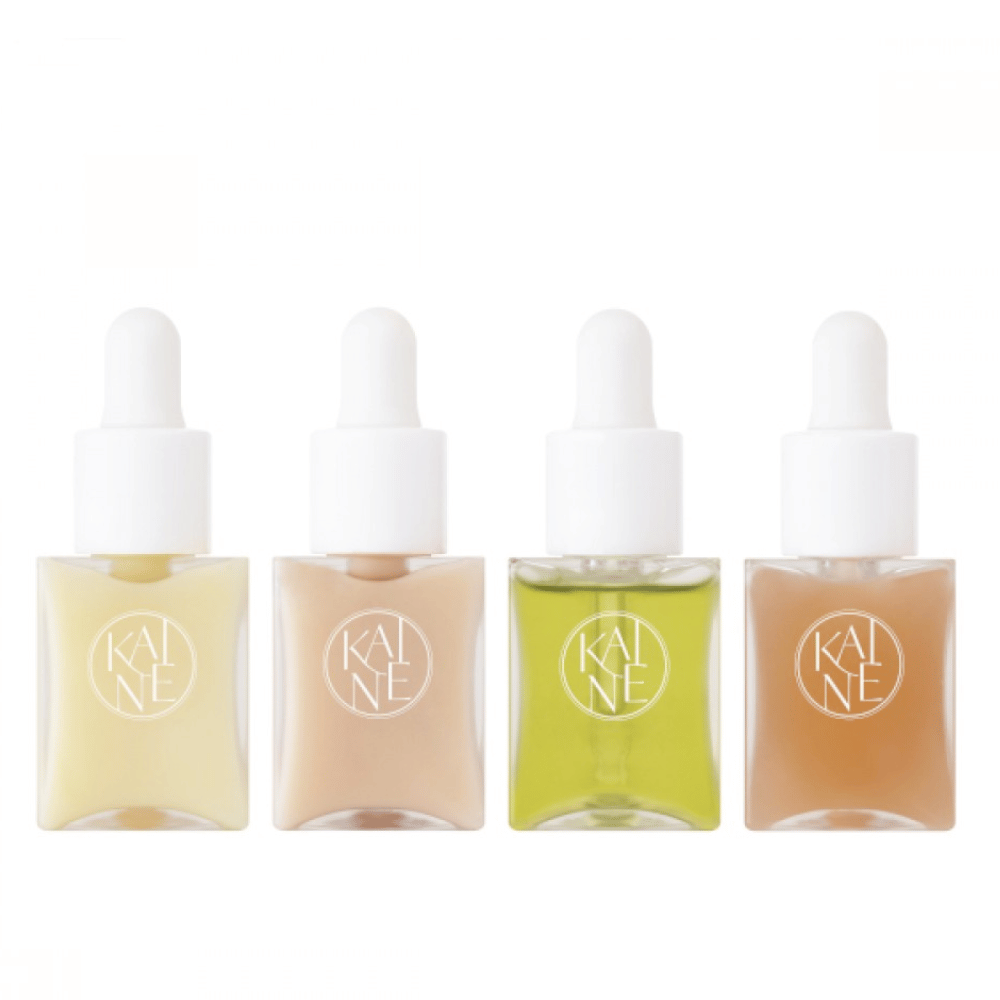 Štiri barvne stekleničke s serumom iz KAINÉ Serum Discovery Kit z zamaškom pipete, zasnovane za zadovoljevanje različnih potreb kože v minimalistični in elegantni embalaži.