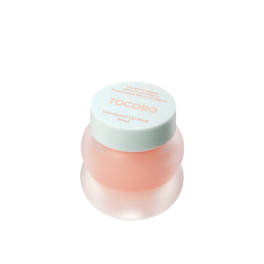 Prikazana je posoda z "Vita Glazed Lip Mask" iz Tocobo. Posoda je okrogla in prozorna s svetlo turkiznim pokrovom. Maska v notranjosti je svetlo roza in zasnovana za vlaženje in nego ustnic. Izdelek ima prostornino 20 ml.