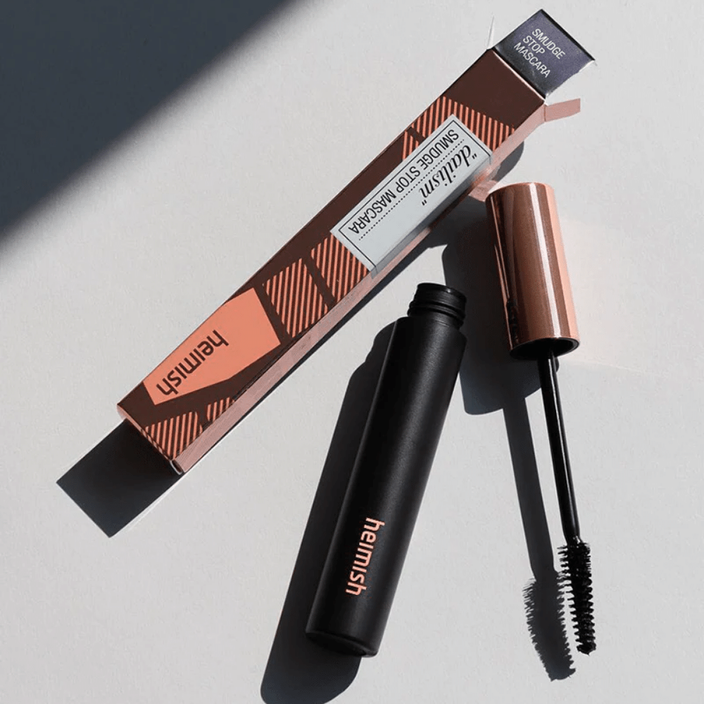 Ena tuba Heimish Dailism Smudge Stop Mascara 9g na beli površini.